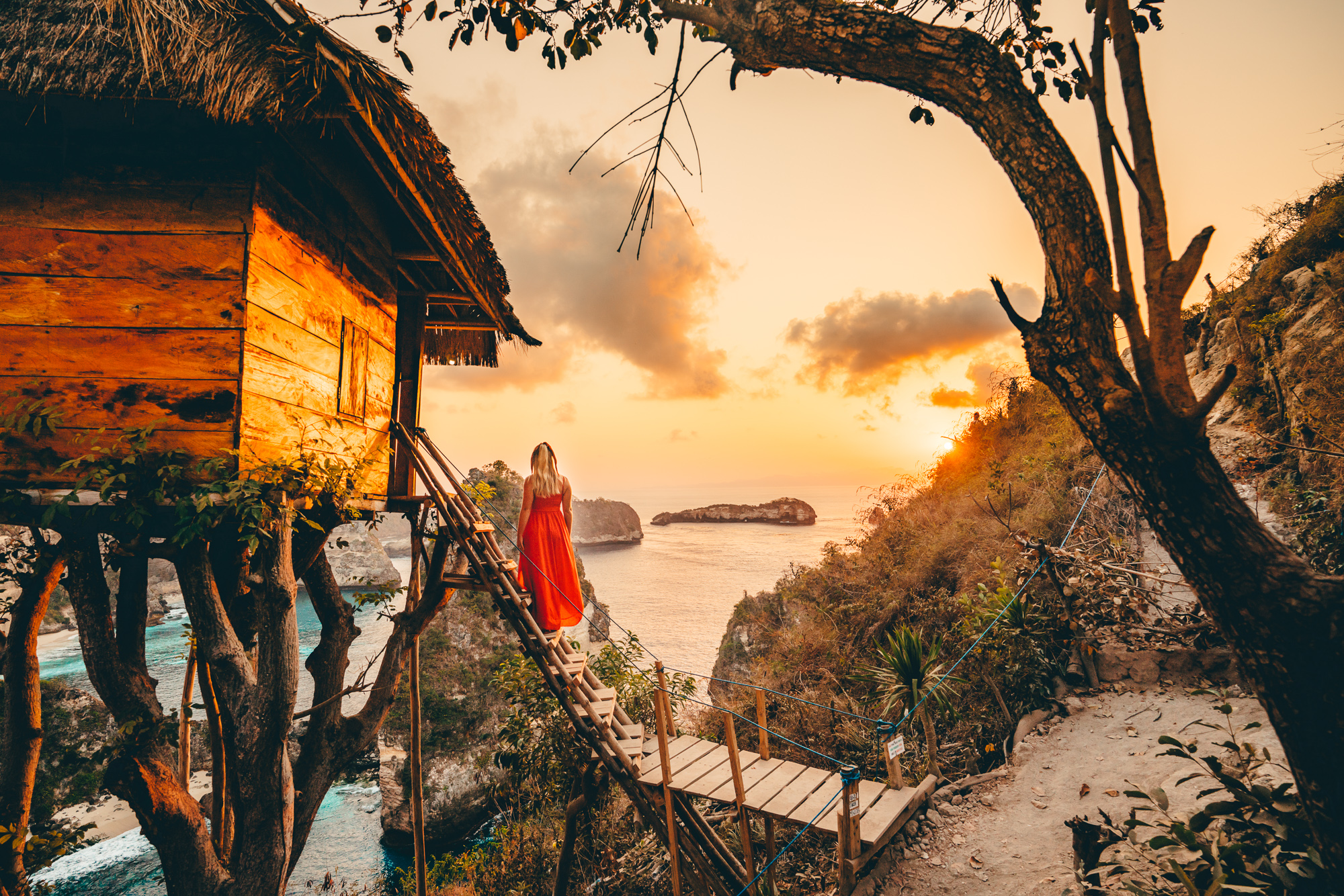 Standing on the stairs of the famous Nusa Penida Tree House overlooking the sunrise